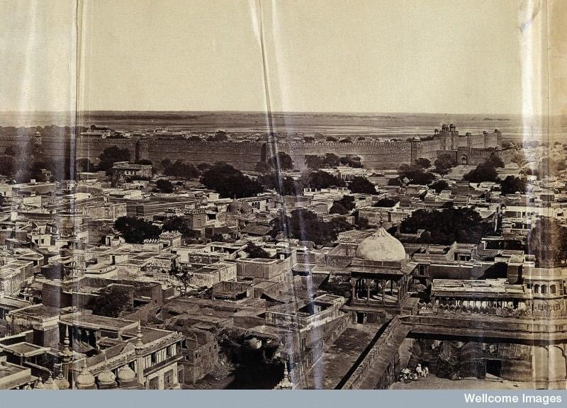 This is a Photograph taken by Felice A. Beato in the year 1858 from the top of the left minaret of Jama Masjid (Delhi). This is the only existing panoramic view shows residential buildings on the north-eastern end between Jama Masjid and Red Fort. Later they were destroyed by British Army. You can notice north eastern corner of the mosque which states its ruin condition during the illegal occupation by Sikh Regiments. You can see one person sitting in the corner fashioned with TURBAN as a headgear, might be a Sikh.